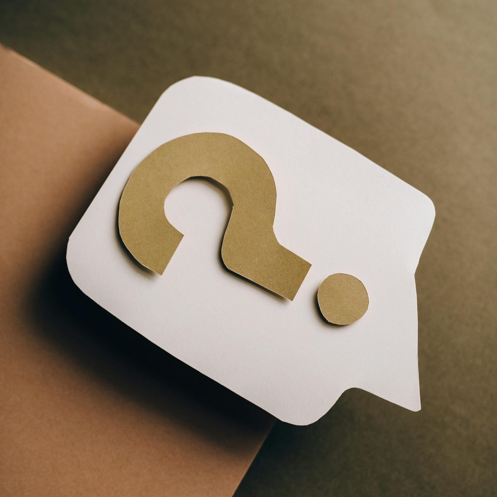 Artistic paper craft of a question mark on neutral background. Ideal for concept themes.